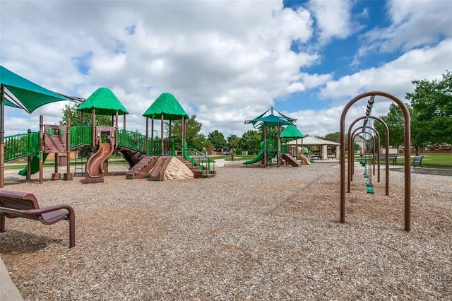 a childrens park with lots of swings and slides