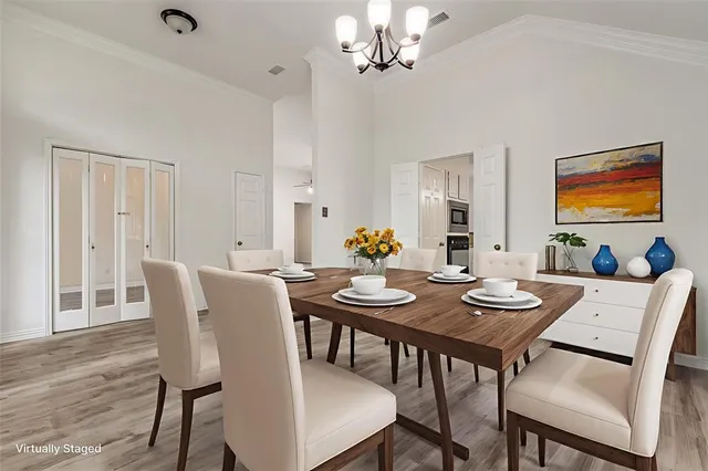 a view of a dining room with furniture wooden floor and chandelier