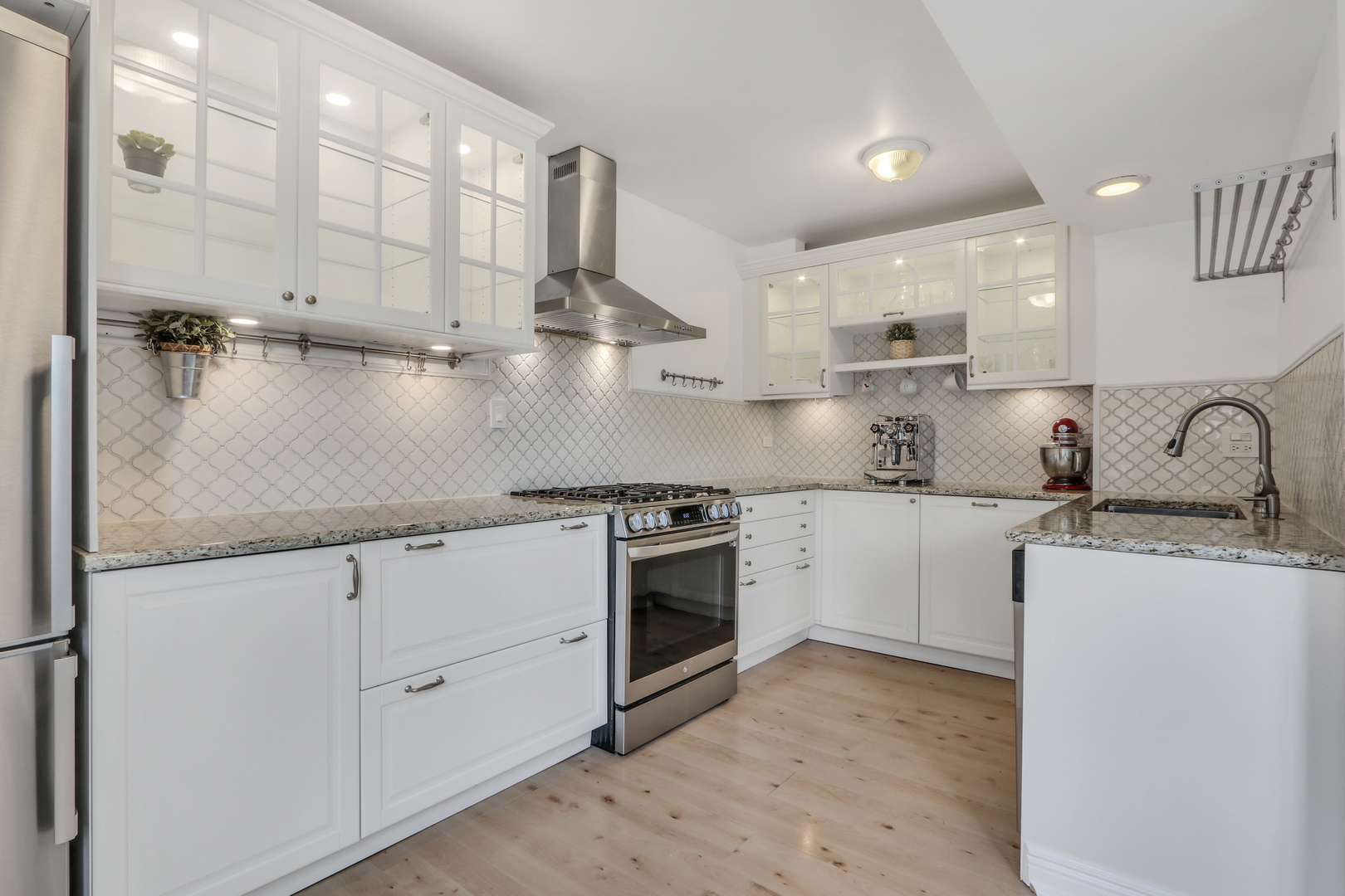 1038 Inverrary Lane Deerfield, IL 60015 - Photo 5 of 19 a kitchen with stainless steel appliances granite countertop a sink a stove and a refrigerator