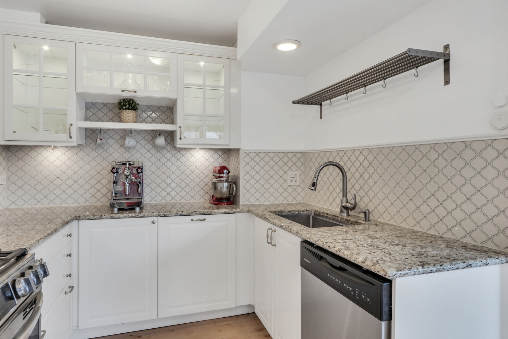 1038 Inverrary Lane Deerfield, IL 60015 - Photo 7 of 19 a kitchen with granite countertop a sink stainless steel appliances and cabinets