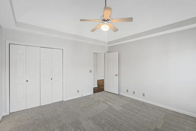 a view of an empty room with a ceiling fan