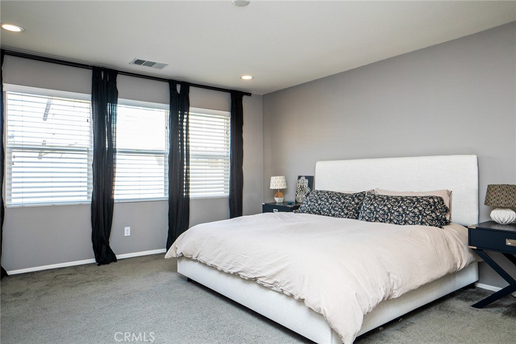4788 Condor Avenue Fontana, CA 92336 - Photo 19 of 49 a bedroom with a large bed and a large window