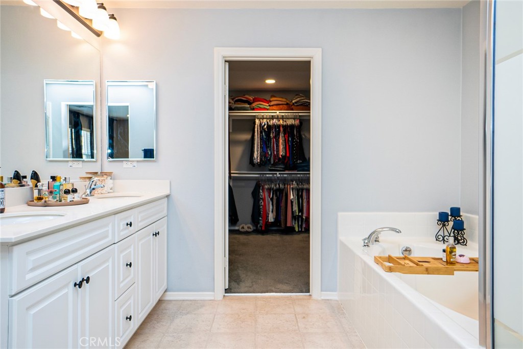 4788 Condor Avenue Fontana, CA 92336 - Photo 32 of 49 a bathroom with a tub sink and mirror