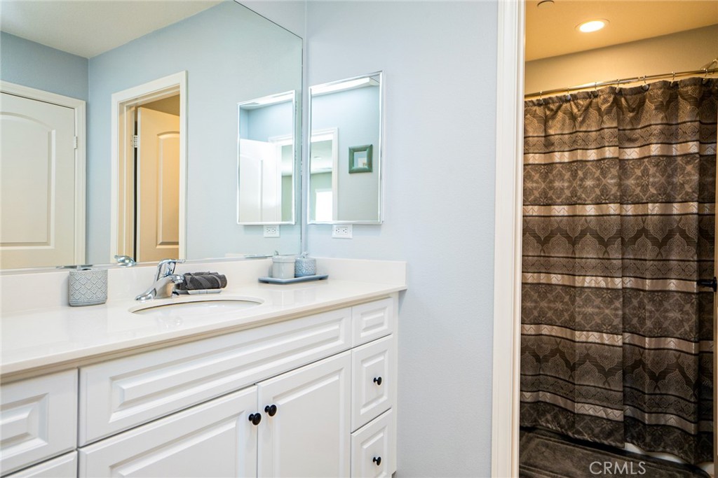 4788 Condor Avenue Fontana, CA 92336 - Photo 34 of 49 a bathroom with a double vanity sink and a mirror