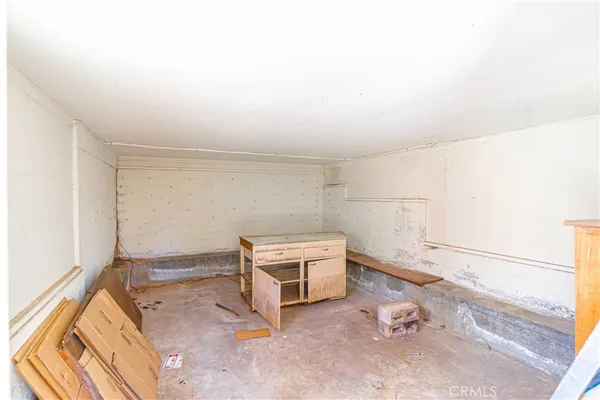 a bedroom with a bed and a flat tv screen on dresser