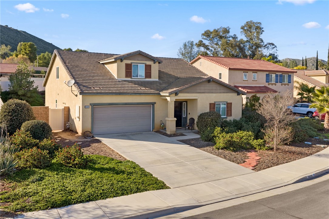 26829 Rodeo Court Winchester, CA 92596 - Photo 4 of 32 a front view of a house with a yard and garage