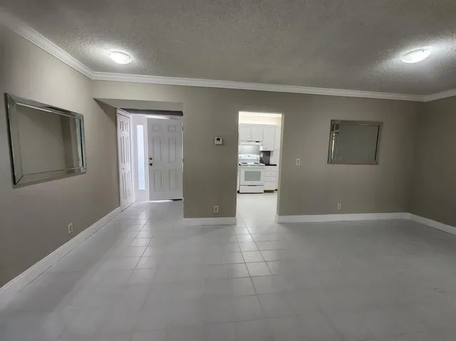 an empty room with closet and a bathroom