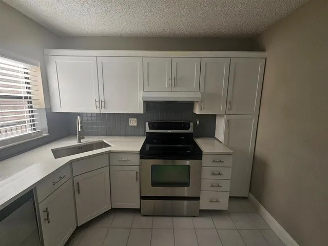 a kitchen with a stove and a sink