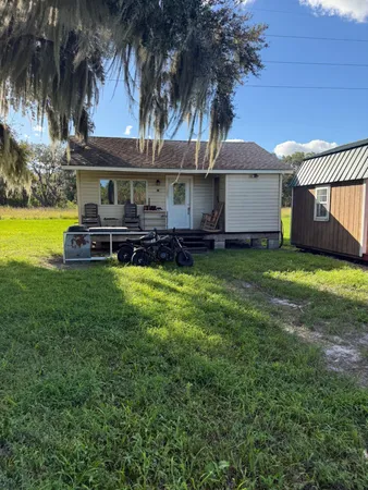 a view of a house with a yard and sitting area