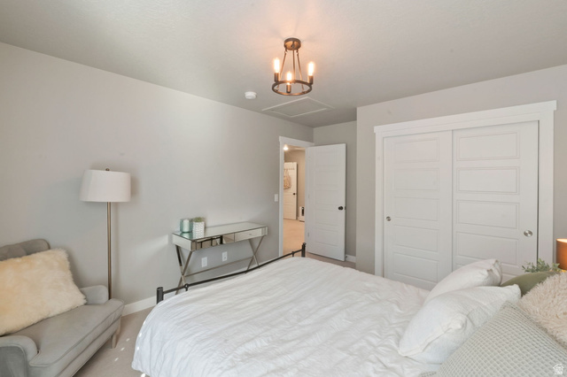 2319 North 3370 West Lehi, UT 84048 - Photo 21 of 30 Bedroom featuring light gray walls, white trim, and a contemporary chandelier