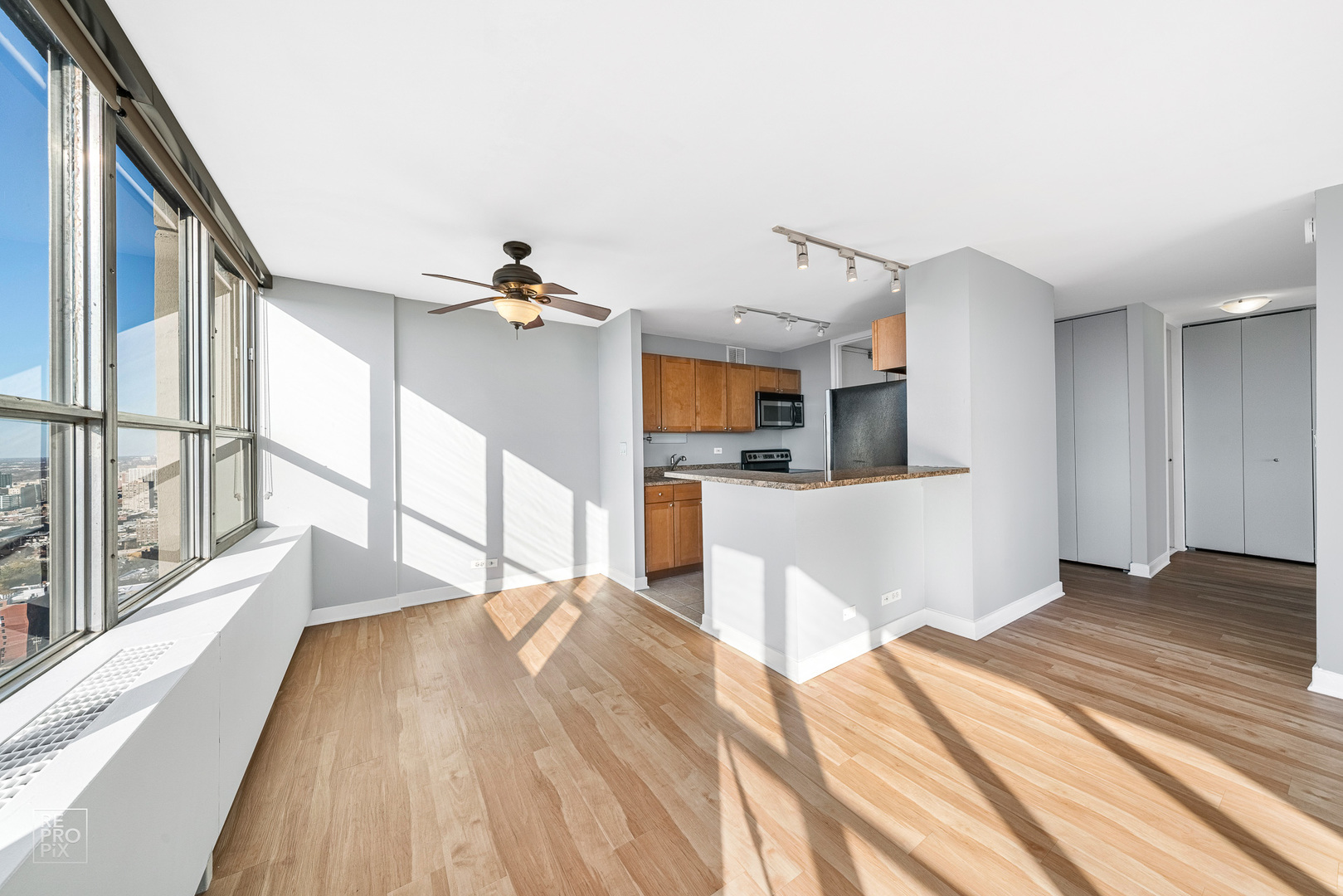 655 West Irving Park Road, Unit 3717 Chicago, IL 60613 - Photo 5 of 22 a view of a kitchen with wooden floor and a kitchen