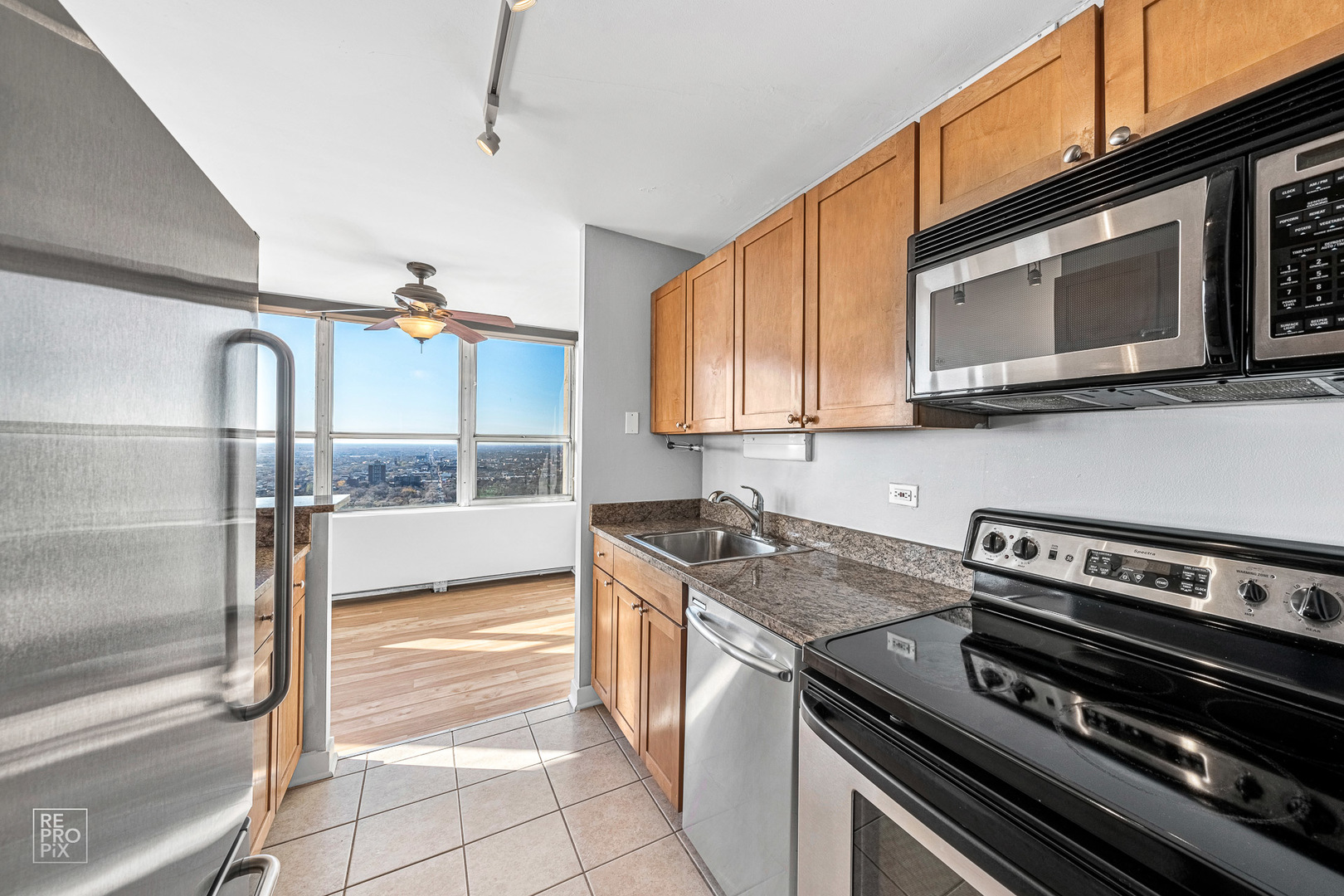 655 West Irving Park Road, Unit 3717 Chicago, IL 60613 - Photo 6 of 22 a kitchen with a stove and a microwave