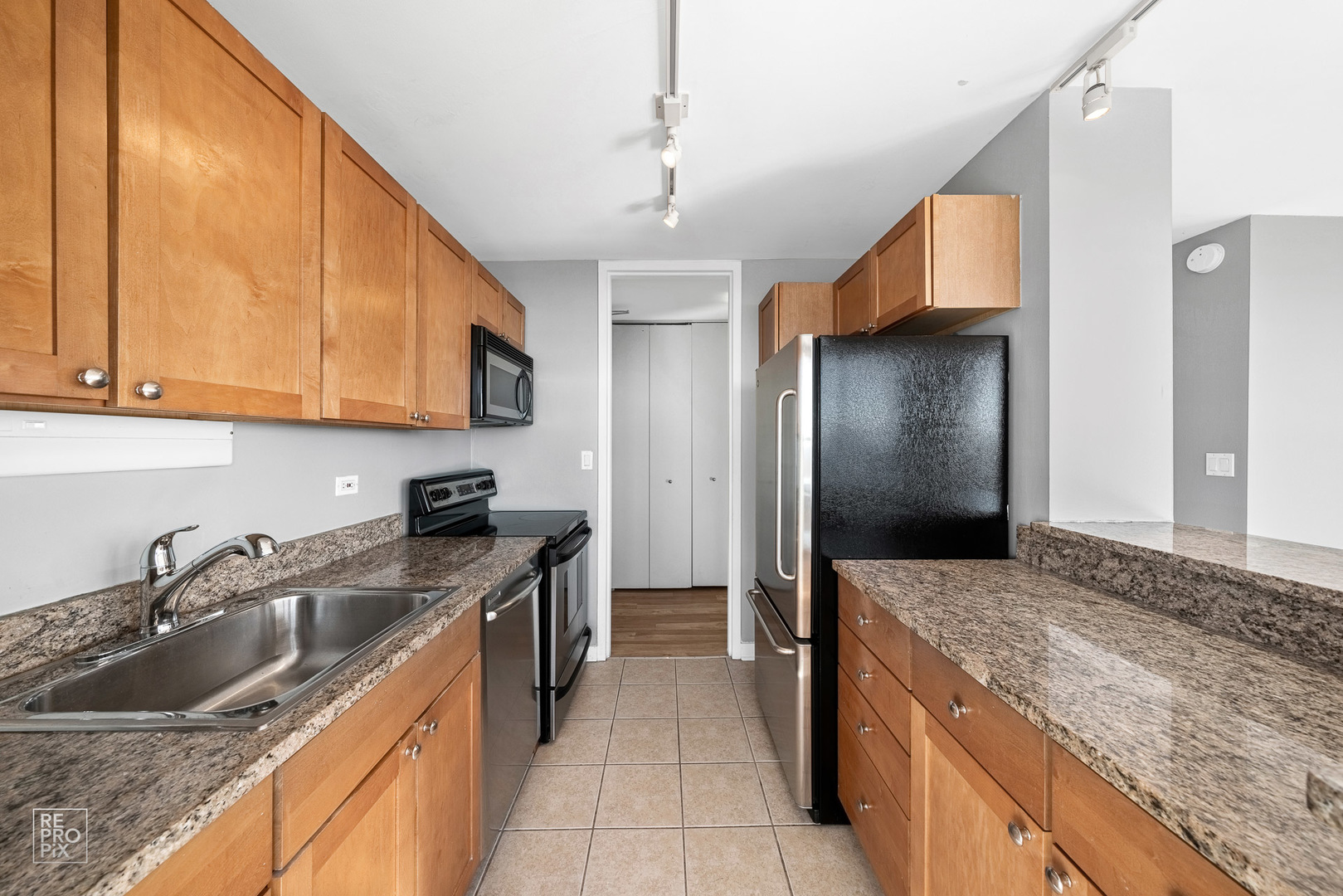 655 West Irving Park Road, Unit 3717 Chicago, IL 60613 - Photo 7 of 22 a kitchen with a sink stove and refrigerator