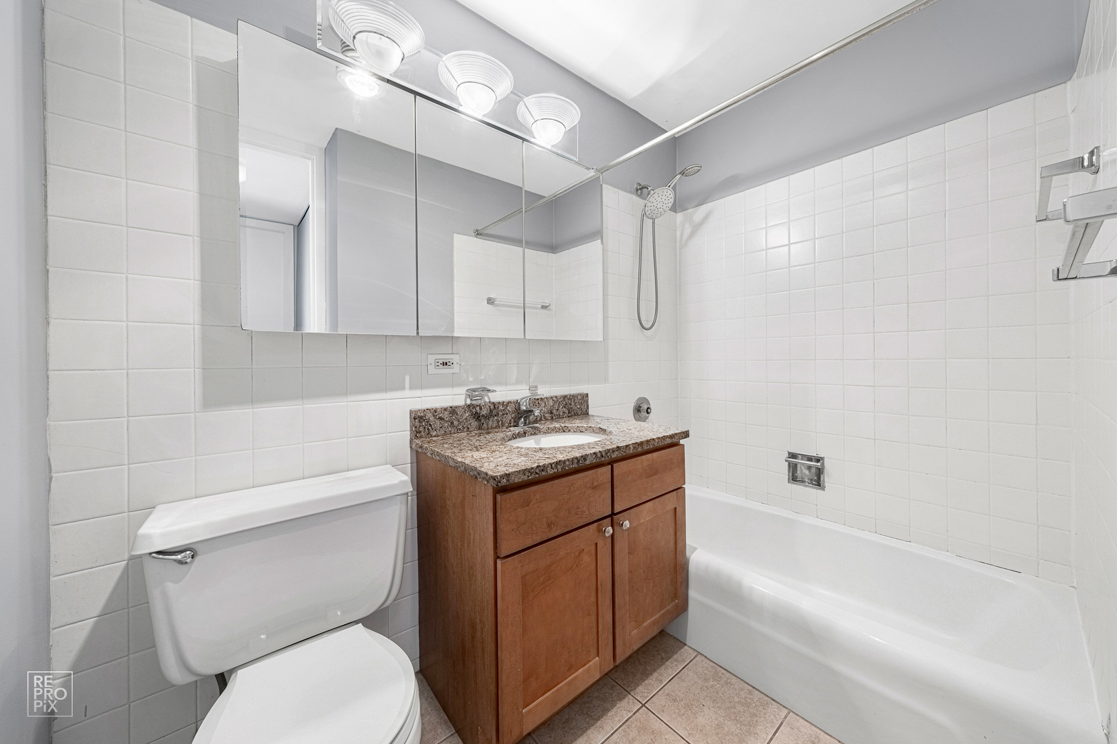 655 West Irving Park Road, Unit 3717 Chicago, IL 60613 - Photo 8 of 22 a bathroom with a sink a toilet and bathtub