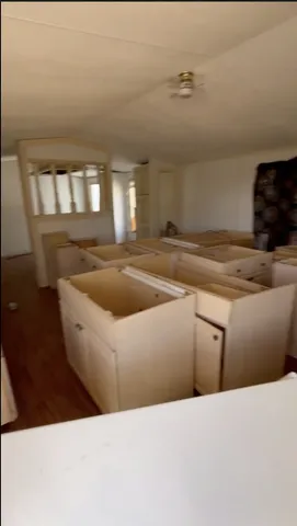 a living room with wooden floor and window