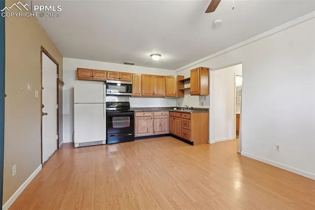a kitchen with stainless steel appliances a refrigerator and a stove top oven