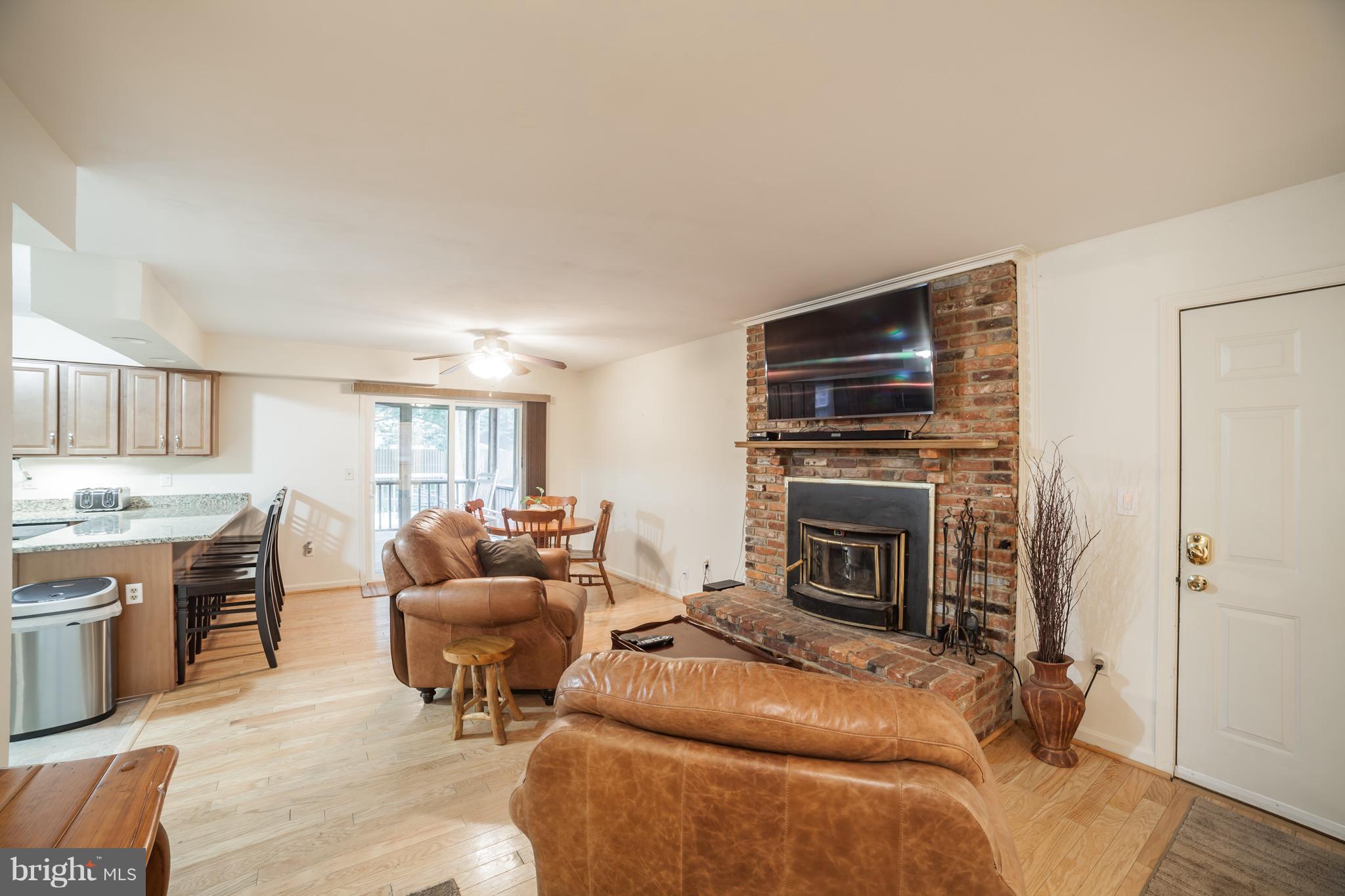 705 Mesquite Road Severn, MD 21144 - Photo 4 of 30 wood burning brick fireplace opens to kitchen