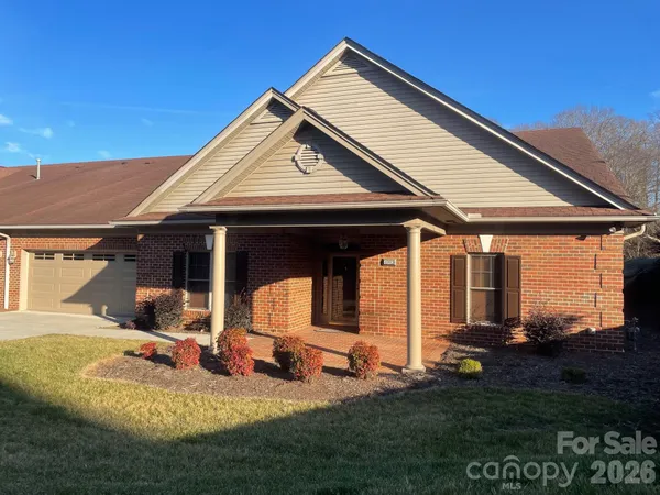 a view of a house with backyard and porch