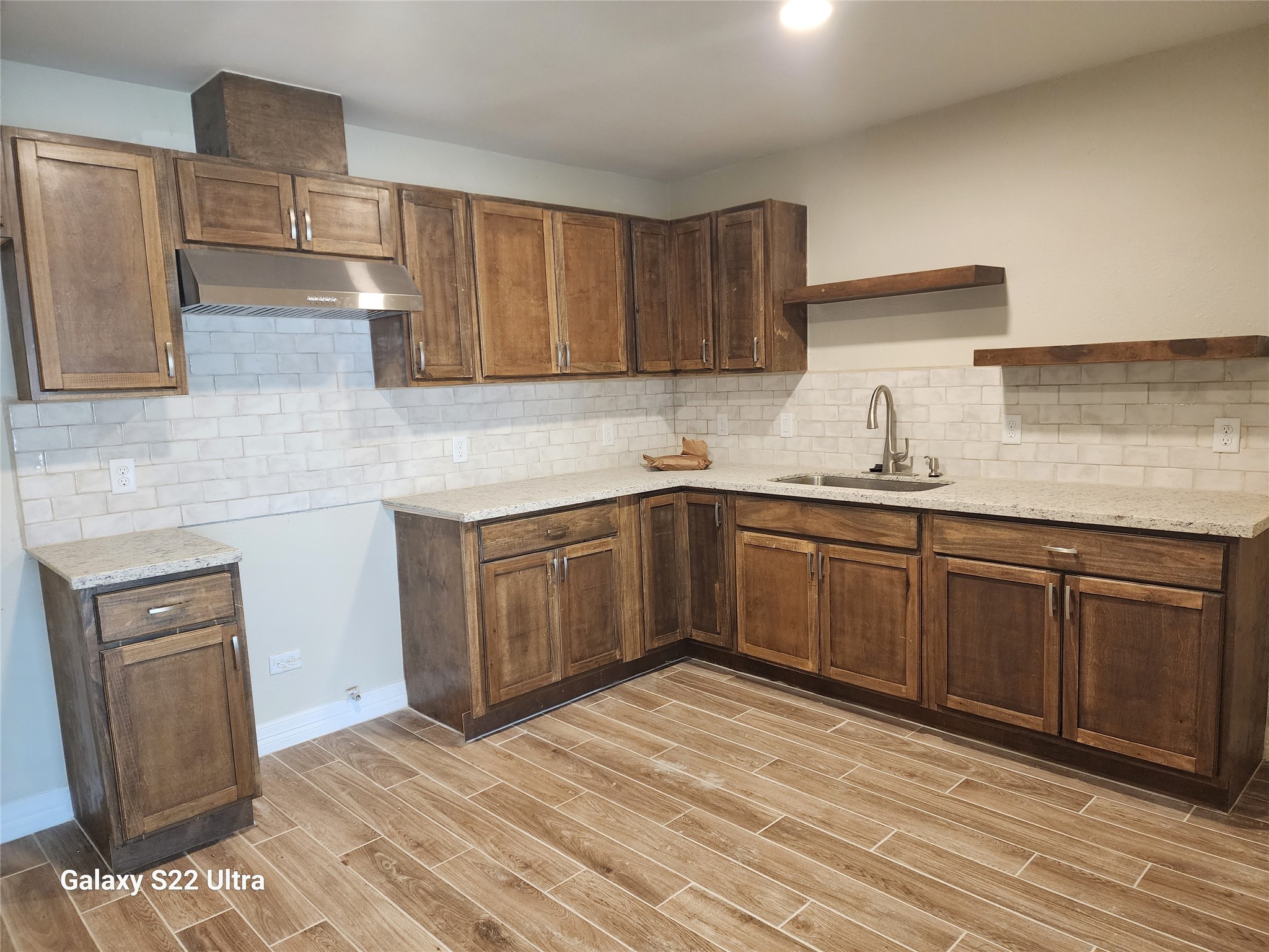 702 McDaniel Street, Unit A Houston, TX 77022 - Photo 6 of 11 a kitchen with a sink a stove and cabinets