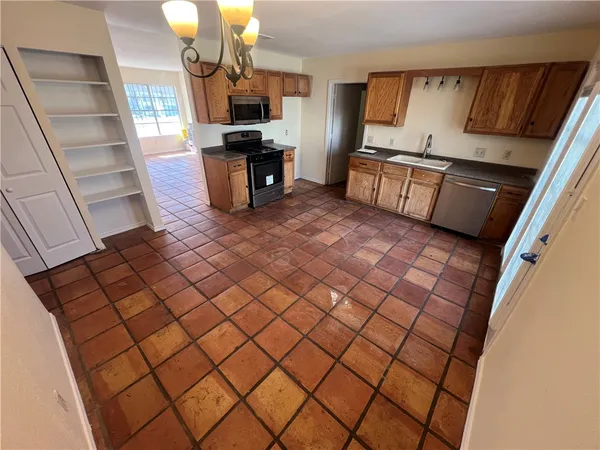 a kitchen with a sink and a stove top oven