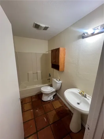 a bathroom with a sink a toilet a mirror and shower