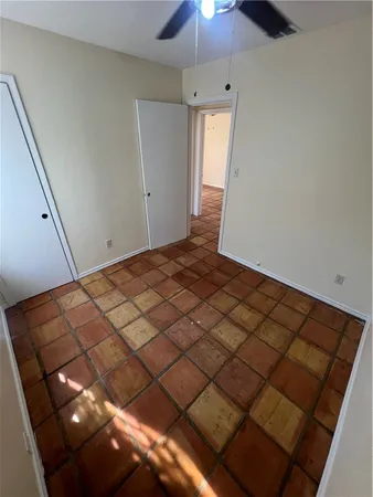 a bedroom with a bed and a ceiling fan