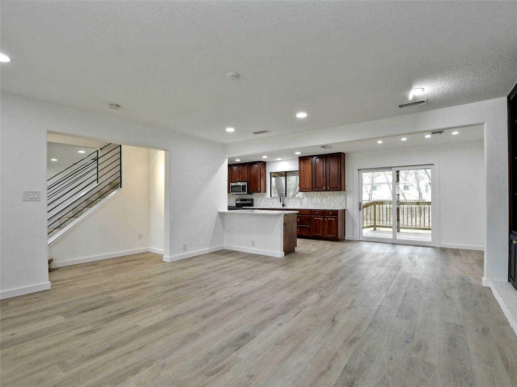 a view of kitchen with microwave and refrigerator