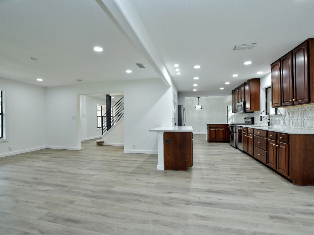 307 Copperleaf Road Lakeway, TX 78734 - Photo 14 of 28 a view of kitchen with stainless steel appliances granite countertop a stove top oven and a sink with granite countertops