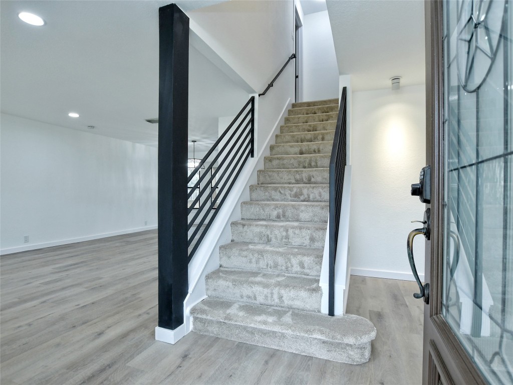307 Copperleaf Road Lakeway, TX 78734 - Photo 6 of 28 a view of a hallway with wooden floor and staircase