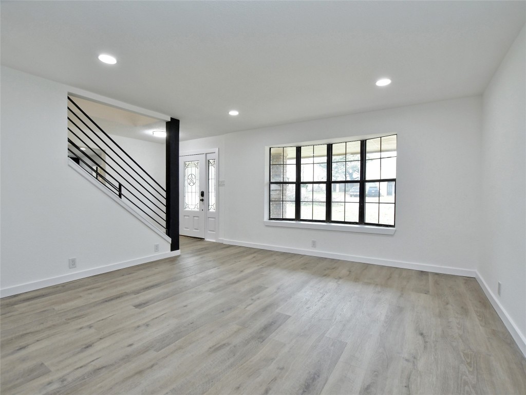 307 Copperleaf Road Lakeway, TX 78734 - Photo 7 of 28 wooden floor in an empty room with a window