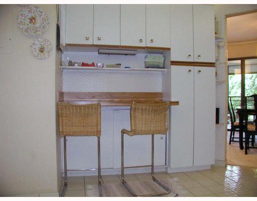 5700 Camino Del Sol, Unit 304 Boca Raton, FL 33433 - Photo 11 of 14 a view of cabinets and wooden floor