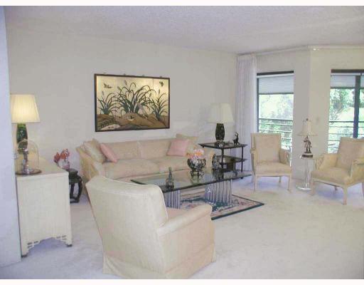 5700 Camino Del Sol, Unit 304 Boca Raton, FL 33433 - Photo 4 of 14 a living room with furniture and a table