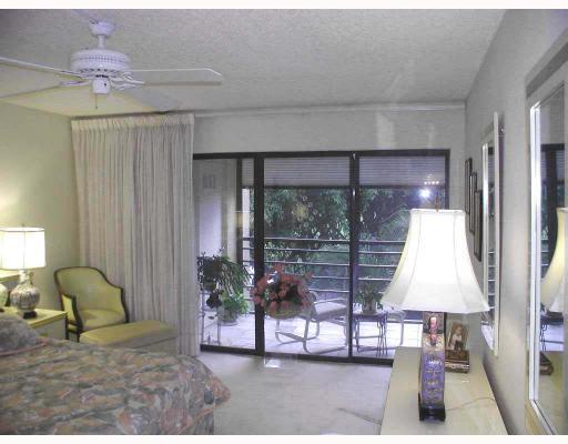 5700 Camino Del Sol, Unit 304 Boca Raton, FL 33433 - Photo 6 of 14 a living room with furniture and a lamp