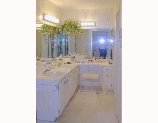 5700 Camino Del Sol, Unit 304 Boca Raton, FL 33433 - Photo 7 of 14 a bathroom with a sink and a mirror