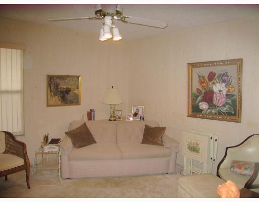 5700 Camino Del Sol, Unit 304 Boca Raton, FL 33433 - Photo 8 of 14 a living room with furniture and a painting
