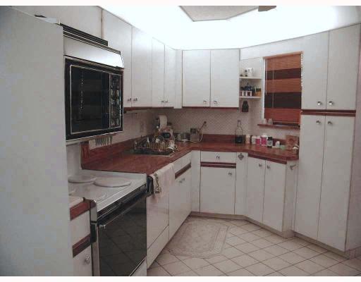 5700 Camino Del Sol, Unit 304 Boca Raton, FL 33433 - Photo 10 of 14 a kitchen with a sink cabinets and black appliances