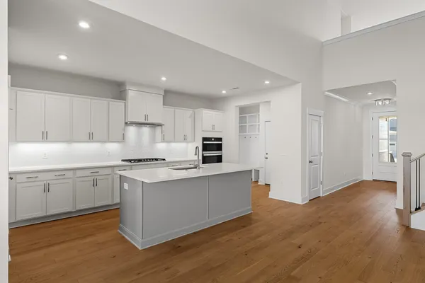 a kitchen with a stove a sink and a refrigerator