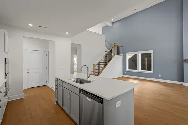 a kitchen with a sink and wooden cabinets