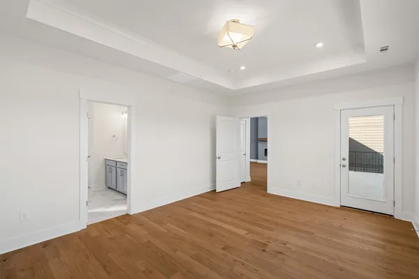 a big room with wooden floor and bathroom