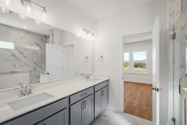 a bathroom with a sink double vanity and a mirror