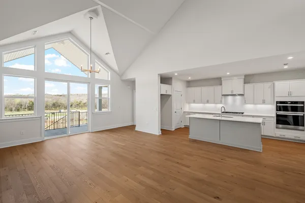 a view of kitchen with wooden floor and electronic appliances