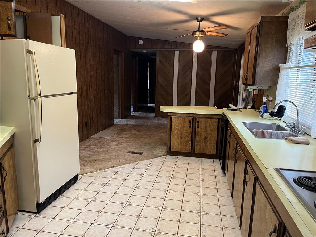 49 Cedar Grove Road Avella, PA 15312 - Photo 13 of 16 a kitchen with a sink a refrigerator and a stove