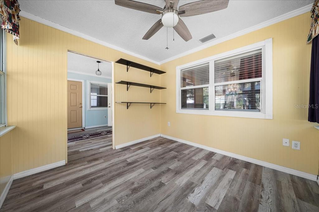 12575 West Edwards Court Inglis, FL 34449 - Photo 12 of 39 a view of empty room with wooden floor and fan