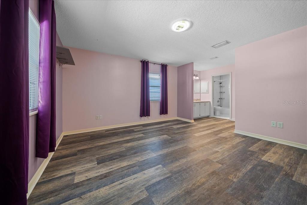 12575 West Edwards Court Inglis, FL 34449 - Photo 13 of 39 a view of an empty room with wooden floor and a window