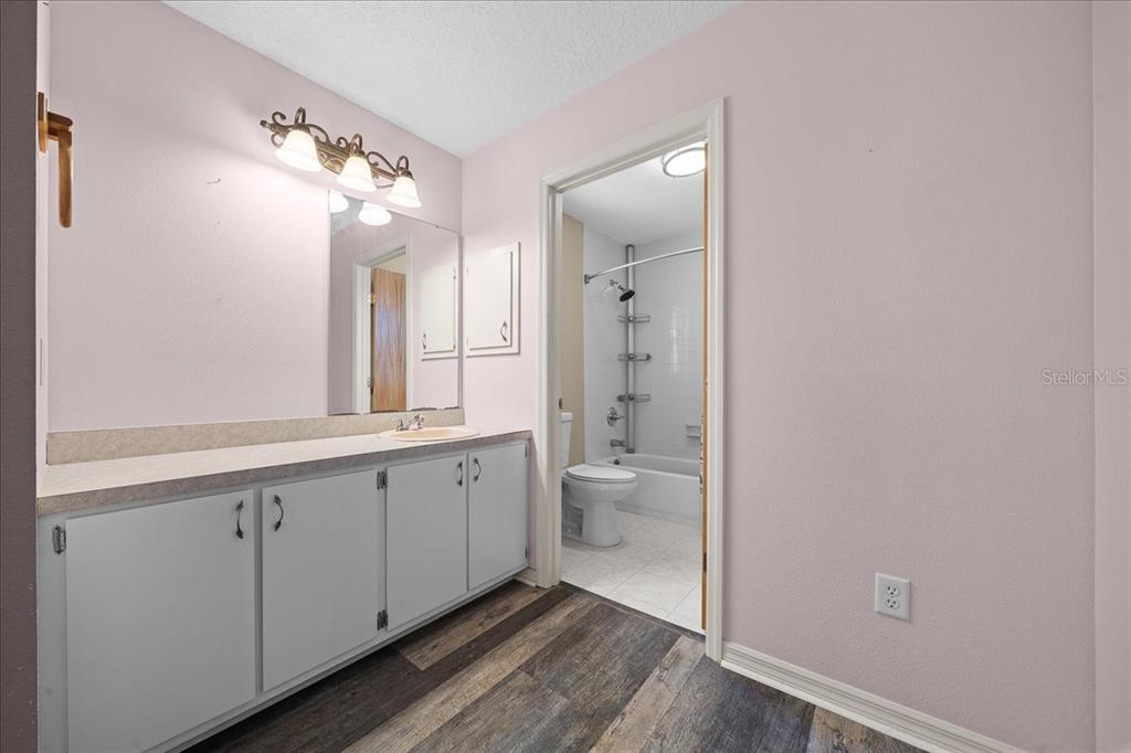 12575 West Edwards Court Inglis, FL 34449 - Photo 15 of 39 a spacious bathroom with a double vanity sink a toilet and a shower