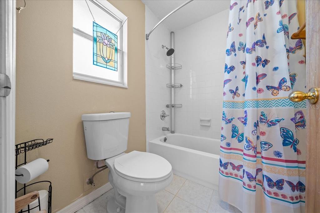 12575 West Edwards Court Inglis, FL 34449 - Photo 16 of 39 a bathroom with a toilet and a shower curtain