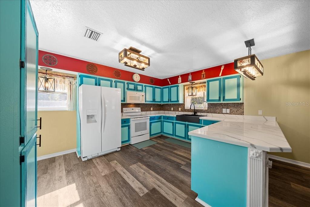 12575 West Edwards Court Inglis, FL 34449 - Photo 9 of 39 a kitchen with stainless steel appliances granite countertop a refrigerator and a stove