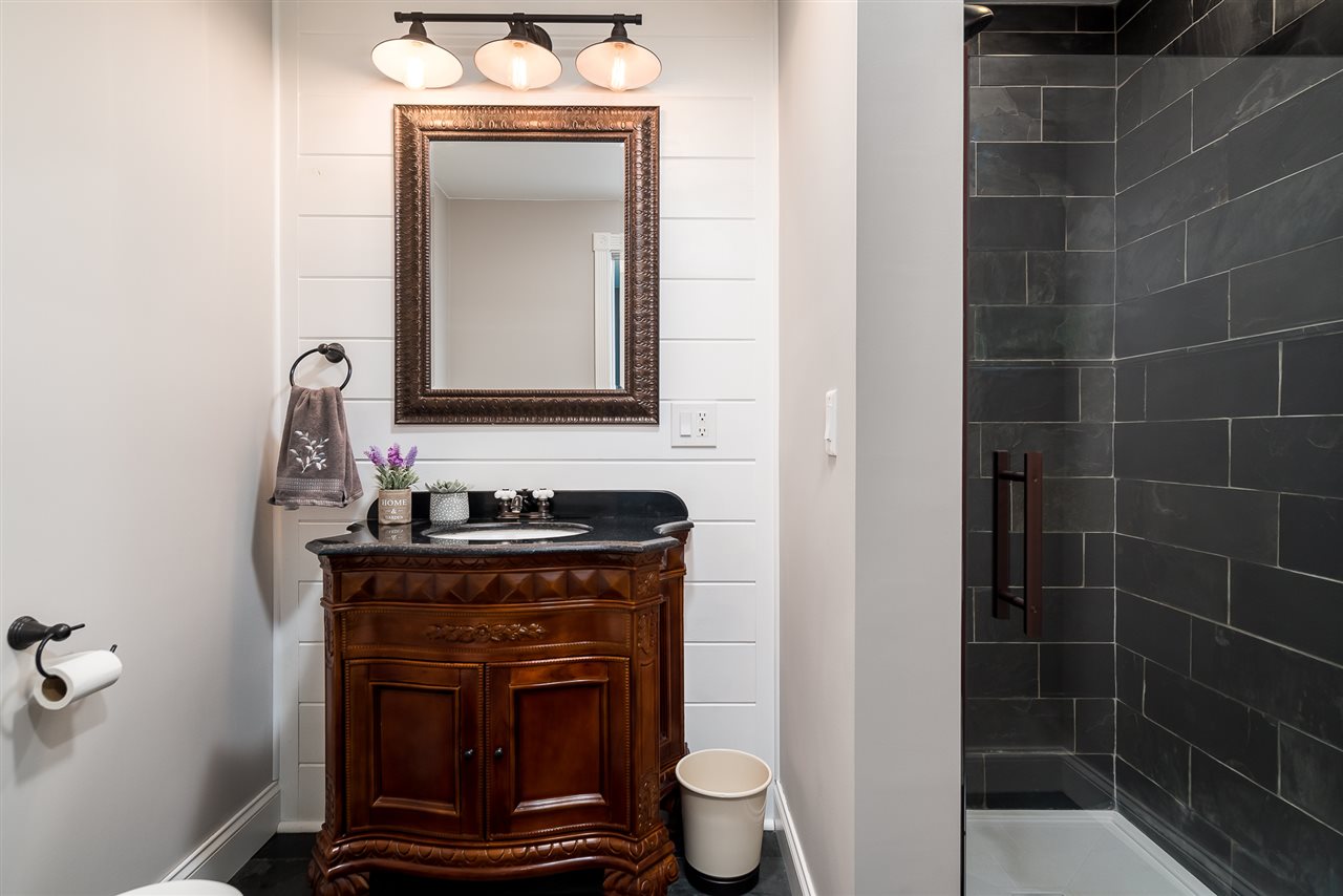 9691 East Cedarville Road Davis, IL 61019 - Photo 27 of 39 a bathroom with a toilet a sink and mirror
