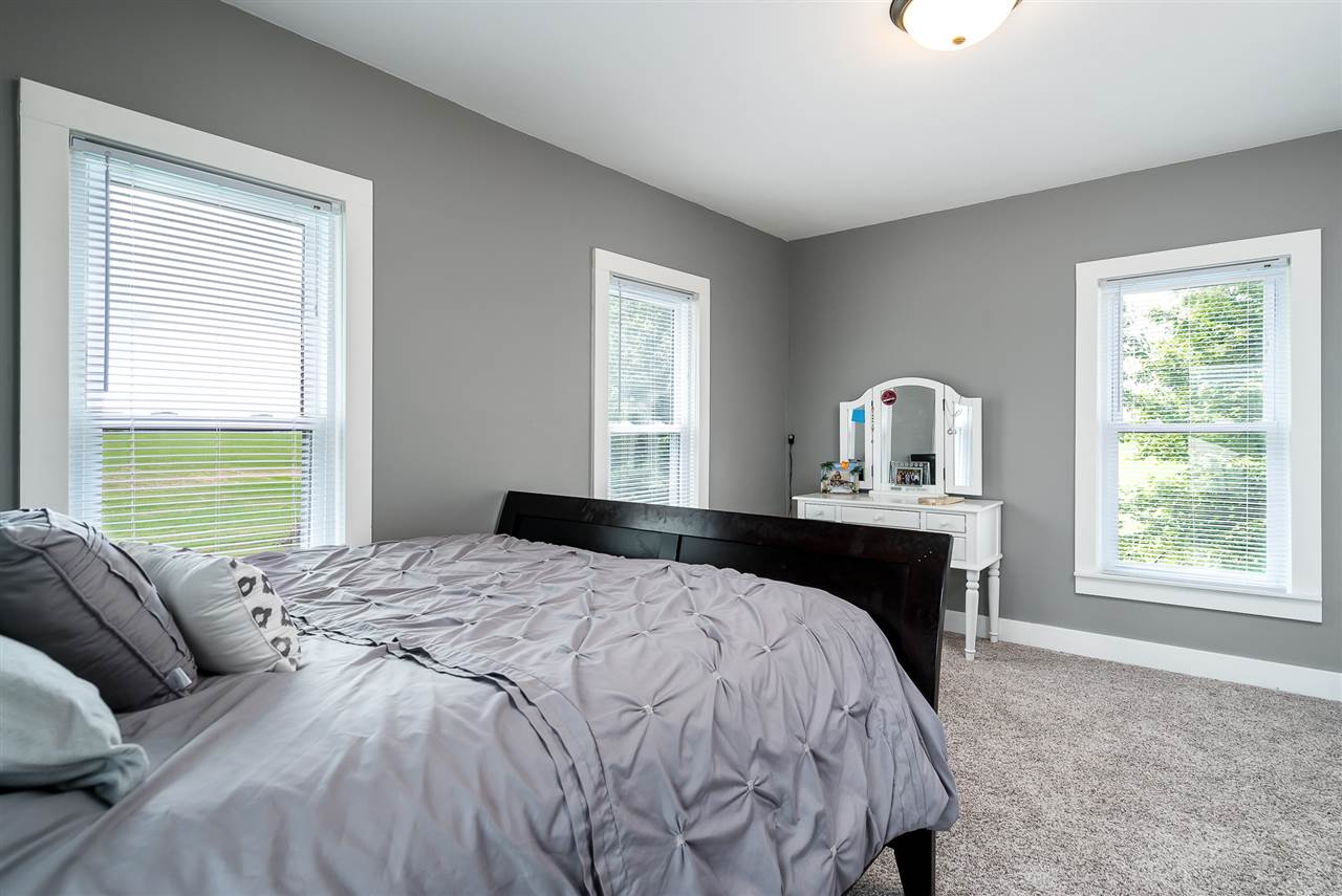 9691 East Cedarville Road Davis, IL 61019 - Photo 30 of 39 a bedroom with a large bed and a window