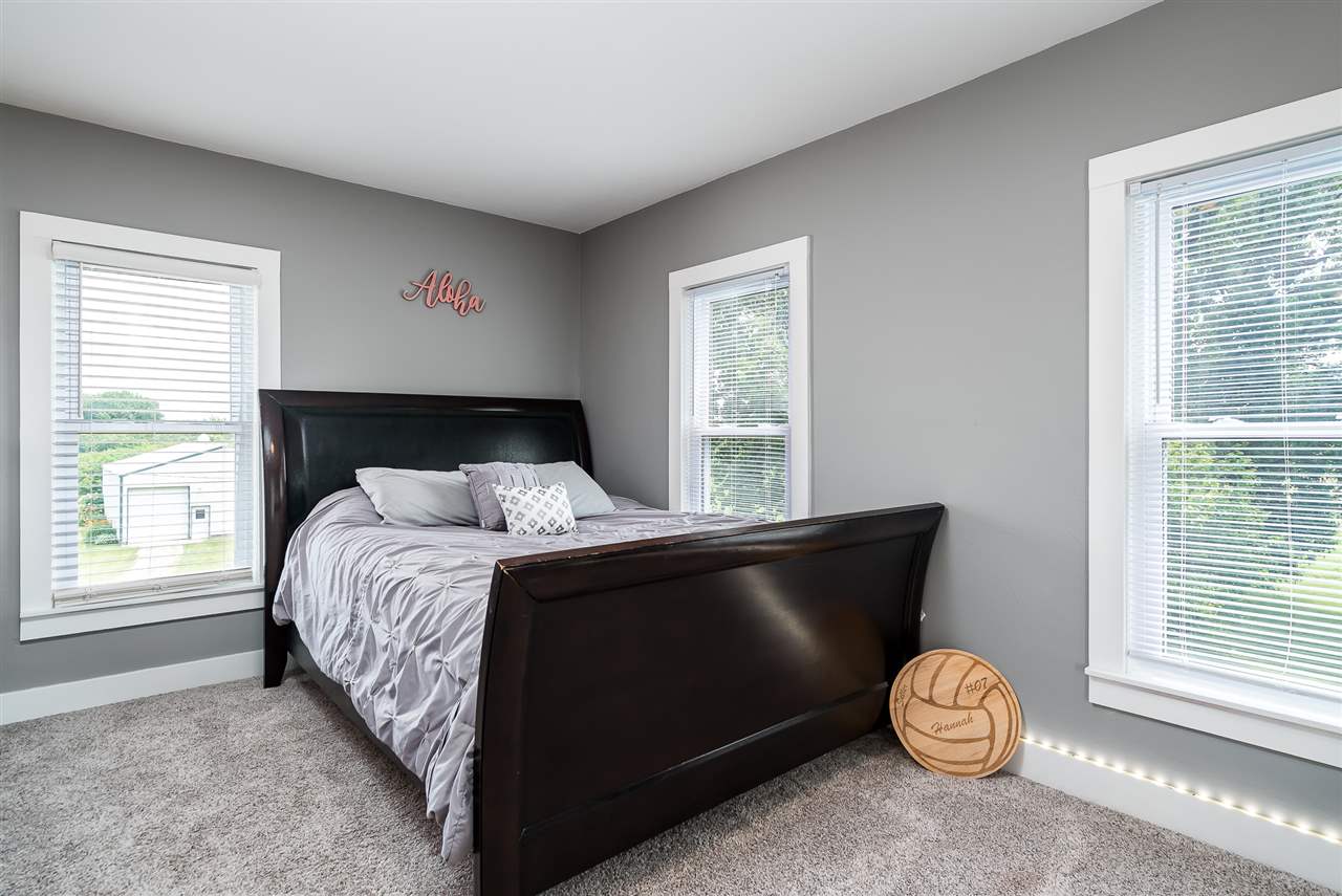 9691 East Cedarville Road Davis, IL 61019 - Photo 37 of 39 a bed sitting in a bedroom next to a window